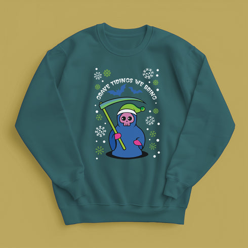 A holiday sweatshirt featuring a cute Grim Reaper holding a scythe, wearing a Santa hat. Above the character is the text "Grave Tidings We Bring," surrounded by festive snowflakes and holiday-themed designs. The combination of spooky and festive elements adds a humorous twist to traditional holiday attire.